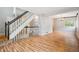 Open-concept space features hardwood floors and easy access to the upper level of the home at 5721 S Jellison St, Littleton, CO 80123