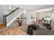 Open-concept living space with wood floors, seamlessly connecting the living and dining areas at 5721 S Jellison St, Littleton, CO 80123