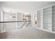 Open loft area with built-in shelving, neutral carpeting, and access to multiple rooms at 5721 S Jellison St, Littleton, CO 80123