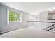 Bright loft space featuring neutral paint, plush carpeting, and abundant natural light from the window at 5721 S Jellison St, Littleton, CO 80123