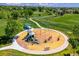 Aerial view of the community playground surrounded by mature trees and green space at 5721 S Jellison St, Littleton, CO 80123