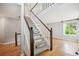 Bright foyer features a carpeted staircase with wooden railings, creating a welcoming entrance at 5721 S Jellison St, Littleton, CO 80123