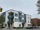 Modern apartment building with balconies and sleek, contemporary design, plus street and city signage at 336 E 1St Ave # 310, Denver, CO 80203