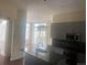 Modern kitchen featuring dark countertops, a sink island, and unique light fixture at 336 E 1St Ave # 310, Denver, CO 80203