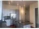 Modern kitchen featuring stainless steel appliances, island, and stylish pendant lighting at 336 E 1St Ave # 310, Denver, CO 80203