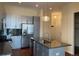 Modern kitchen with stainless steel appliances, an island with a sink and a pendant light at 336 E 1St Ave # 310, Denver, CO 80203