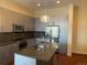 Modern kitchen features stainless steel appliances, gray cabinets, and center island with seating at 336 E 1St Ave # 310, Denver, CO 80203