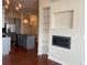 Open-concept living space with kitchen, fireplace, and custom built-in shelving at 336 E 1St Ave # 310, Denver, CO 80203