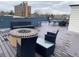 Inviting rooftop deck features outdoor seating, modern fire pit, and panoramic city views at 336 E 1St Ave # 310, Denver, CO 80203