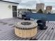 Outdoor kitchen features a gas grill, fire pit with seating, and deck for entertaining guests at 336 E 1St Ave # 310, Denver, CO 80203