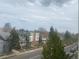 Neighborhood street view highlighting diverse homes and lush trees under a cloudy sky at 336 E 1St Ave # 310, Denver, CO 80203