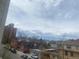 Street view showing neighborhood houses, apartment buildings, and parked cars at 336 E 1St Ave # 310, Denver, CO 80203