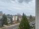 Neighborhood street view highlighting diverse homes and lush trees under a cloudy sky at 336 E 1St Ave # 310, Denver, CO 80203