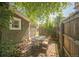 Cozy backyard patio with table and chairs, shaded by mature trees at 3968 Winona Ct, Denver, CO 80212