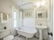 Charming bathroom features a clawfoot tub, pedestal sink, and classic fixtures for a vintage feel at 3968 Winona Ct, Denver, CO 80212