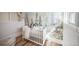 Charming Bedroom features nature-themed wallpaper, a white crib, and a cozy decor at 3968 Winona Ct, Denver, CO 80212