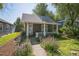 Charming home with a covered front porch and a beautifully landscaped yard at 3968 Winona Ct, Denver, CO 80212