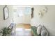 Inviting hallway with a green bench, decorative accents, and a view of the front door at 3968 Winona Ct, Denver, CO 80212
