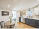 Stylish kitchen with modern appliances, open shelving, and a cozy breakfast nook at 3968 Winona Ct, Denver, CO 80212
