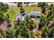 Aerial view showcasing the house and guest house, including parking for RV, plus mature trees at 8045 S Wagon Wheel Rd, Morrison, CO 80465