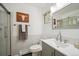 Clean, well-lit bathroom featuring a modern vanity, toilet, and a glass-enclosed shower at 8045 S Wagon Wheel Rd, Morrison, CO 80465