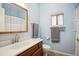 Cozy bathroom with wood vanity, sink, and shower with a white curtain at 8045 S Wagon Wheel Rd, Morrison, CO 80465