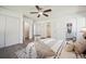 Comfortable bedroom featuring a ceiling fan, ensuite bathroom, and ample closet space with a modern interior design at 8045 S Wagon Wheel Rd, Morrison, CO 80465