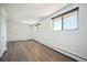 Light and airy bedroom featuring wood-look floors, double door closet, and windows at 8045 S Wagon Wheel Rd, Morrison, CO 80465
