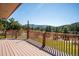 Picturesque outdoor deck showcases scenic views of a mountain landscape with lush greenery and clear blue skies at 8045 S Wagon Wheel Rd, Morrison, CO 80465