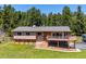 Charming single-Gathering home with a stone facade, a cozy deck, and a well-maintained lawn at 8045 S Wagon Wheel Rd, Morrison, CO 80465