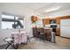 Efficient kitchen with breakfast bar, modern appliances, and natural light at 8045 S Wagon Wheel Rd, Morrison, CO 80465