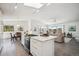 Spacious kitchen featuring a granite island with seating, modern appliances, and open access to the living area at 8045 S Wagon Wheel Rd, Morrison, CO 80465