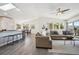 Open-concept living area with vaulted ceilings, modern fixtures, and seamless access to the dining area and kitchen at 8045 S Wagon Wheel Rd, Morrison, CO 80465