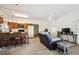 Open concept living area with wood floors, a kitchen with a breakfast bar, and a living room with recliners at 8045 S Wagon Wheel Rd, Morrison, CO 80465