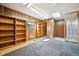 Versatile living space with wood paneling, sky light, and built-in shelving at 8045 S Wagon Wheel Rd, Morrison, CO 80465