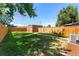 A spacious backyard features lush grass, a wooden fence, and a charming brick outbuilding at 2821 N Harrison St, Denver, CO 80205