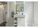 Bright bathroom featuring a modern white vanity, stylish subway tile, and a well-lit atmosphere at 2821 N Harrison St, Denver, CO 80205