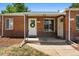 Charming brick home with a covered porch and well-maintained landscaping at 2821 N Harrison St, Denver, CO 80205