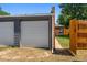 A three-car garage provides ample parking space and features a charming brick accent wall at 2821 N Harrison St, Denver, CO 80205