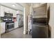 Modern kitchen layout with stainless steel appliances and adjacent laundry area at 2821 N Harrison St, Denver, CO 80205