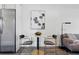 Modern kitchenette featuring stainless steel appliances and an adjacent living room at 2821 N Harrison St, Denver, CO 80205