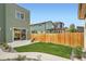 Landscaped backyard featuring a lawn, patio area, and privacy fence at 2466 S Cherokee St, Denver, CO 80223