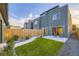 Private backyard with well-maintained lawn, a patio, and modern home exterior at 2466 S Cherokee St, Denver, CO 80223