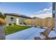 Newly landscaped backyard area featuring green lawn, concrete patio, and modern design at 2466 S Cherokee St, Denver, CO 80223