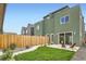 Backyard showcasing a privacy fence, small lawn, and outdoor seating area at 2466 S Cherokee St, Denver, CO 80223