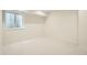 Carpeted basement room with a window well providing natural light at 2466 S Cherokee St, Denver, CO 80223
