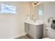 Bright bathroom featuring a sink with a view and a stylish toilet at 2466 S Cherokee St, Denver, CO 80223
