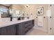 Modern bathroom with double vanity, sleek fixtures, and elegant tile flooring at 2466 S Cherokee St, Denver, CO 80223