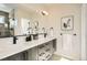 Modern bathroom featuring double sinks, sleek vanity, and a glass shower door at 2466 S Cherokee St, Denver, CO 80223