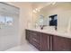 Bathroom featuring a double vanity with white countertops and a dark wood color at 2466 S Cherokee St, Denver, CO 80223
